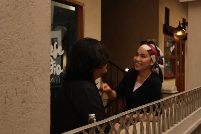 Addin and Umairah chatting by a staircase